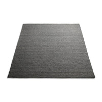 Textured dark gray area rug with a subtle, woven pattern, perfect for modern decor.