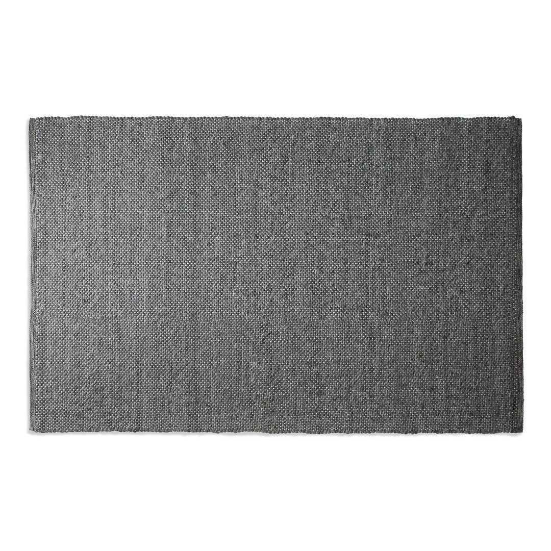 Gray textured rug with subtle variations, featuring a minimalist design for modern decor.