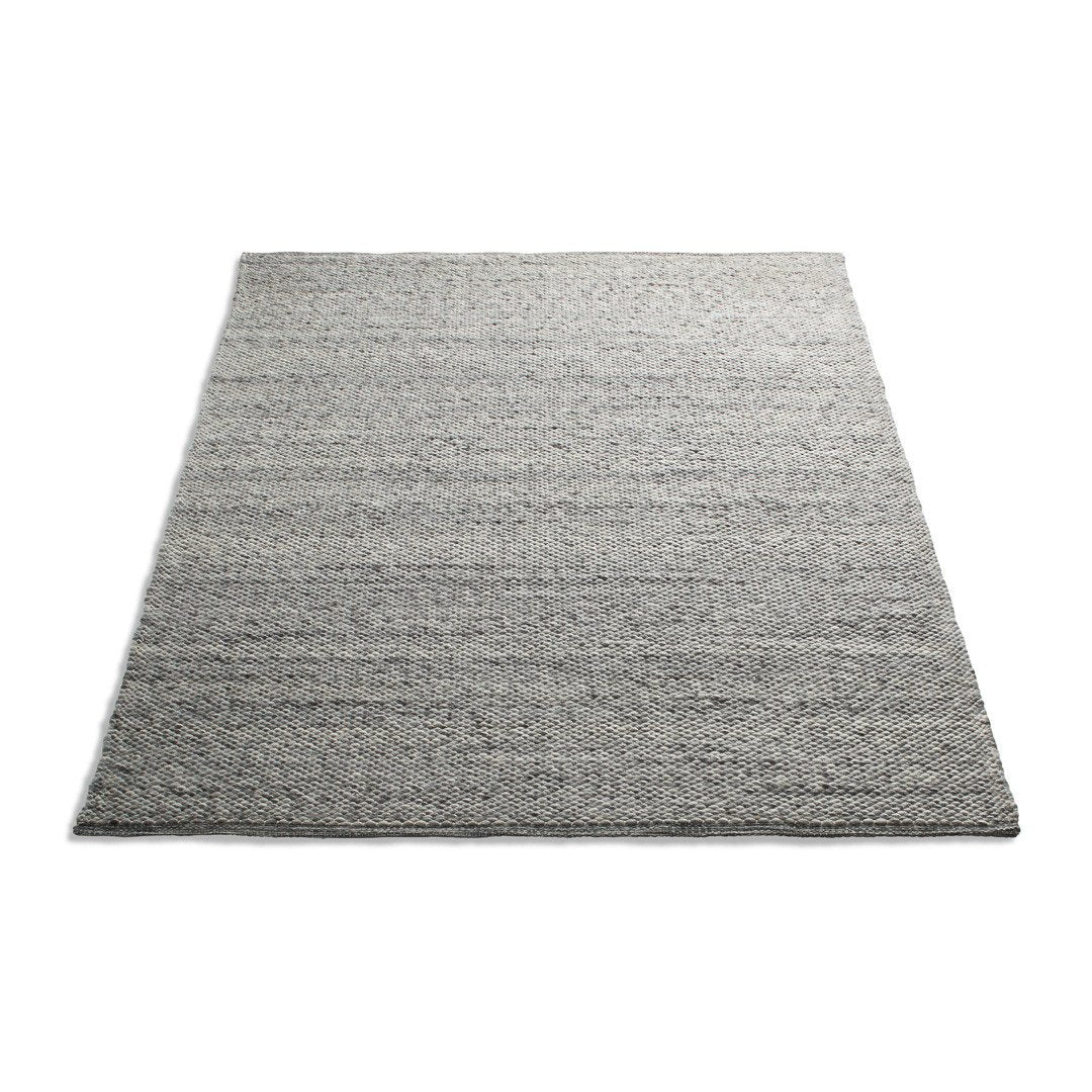 Gray area rug with textured stripes in varying shades of gray, adding depth and style to any space.