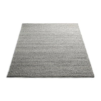 Gray area rug with textured stripes in varying shades of gray, adding depth and style to any space.