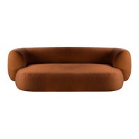 Rust-colored modern sofa with a sleek, minimalist design and soft, curved shapes. Ideal for contemporary interiors.