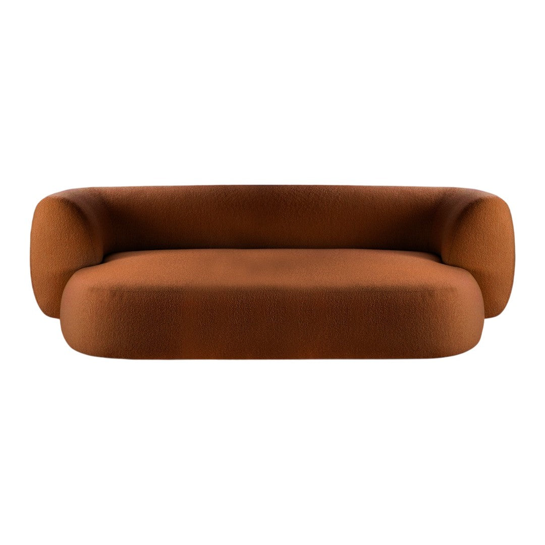 Rust-colored sofa with a sleek, modern design and smooth, rounded edges. Perfect for contemporary interiors.