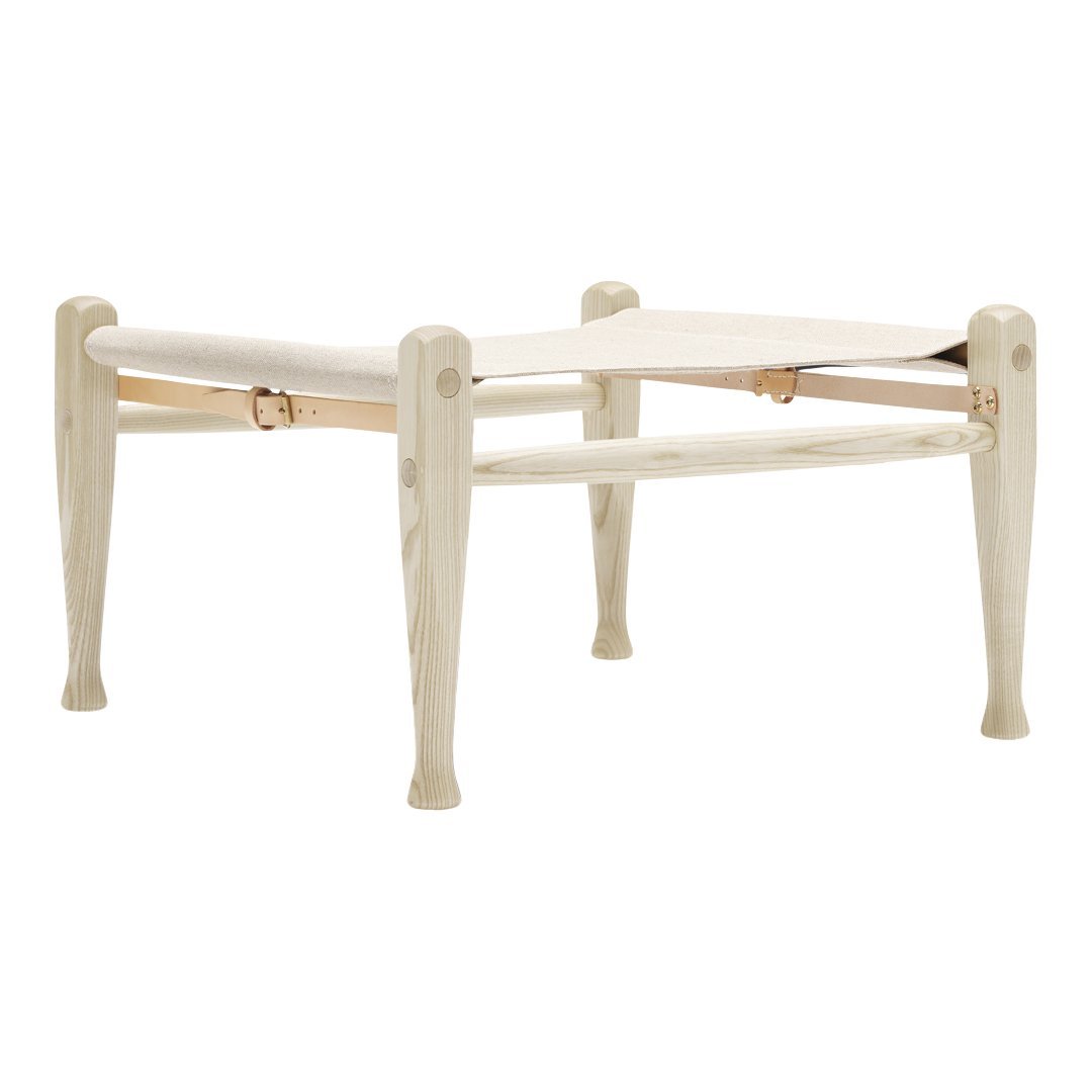 Cream-colored wooden stool with a smooth finish and simple, patterned legs. Ideal for versatile home decor.