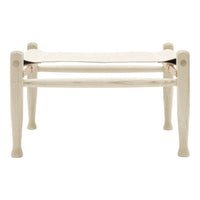 Light wooden bench with a smooth, cream-colored fabric seat, featuring a minimalist design and elegant finish.