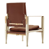 Brown leather armchair with a light cream frame, showcasing a minimalist design and sleek lines.