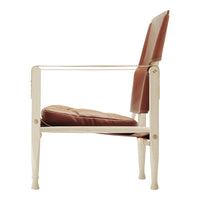 Side view of a chair featuring a cream frame and rich brown cushions, blending modern design with warm tones.