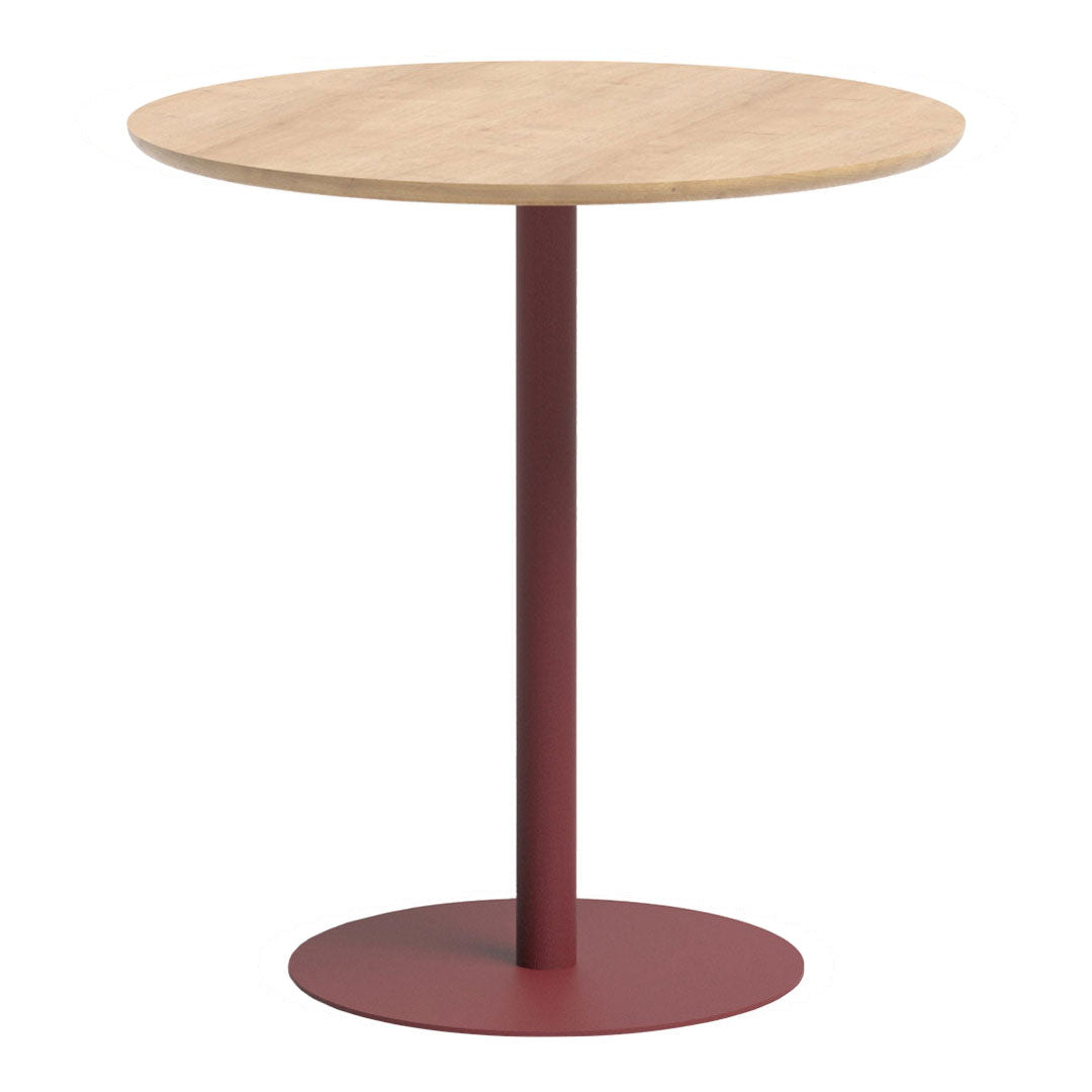 Round wooden table with a natural wood top and a burgundy metal base, featuring a minimalist design.