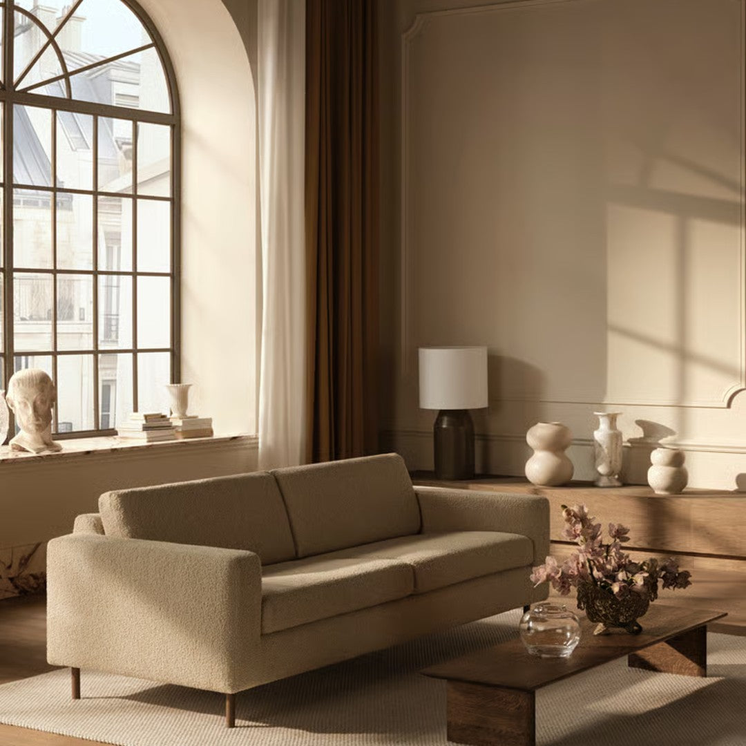 Beige sofa with minimalist design, paired with earthy tones in a soft, stylish living room setting.