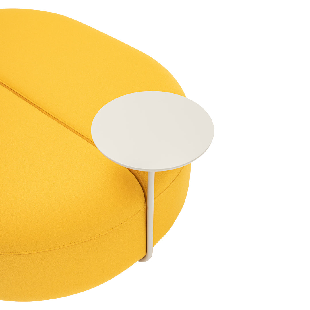 Bright yellow rounded sofa with a sleek white side table for a modern aesthetic. Perfect for vibrant living spaces.