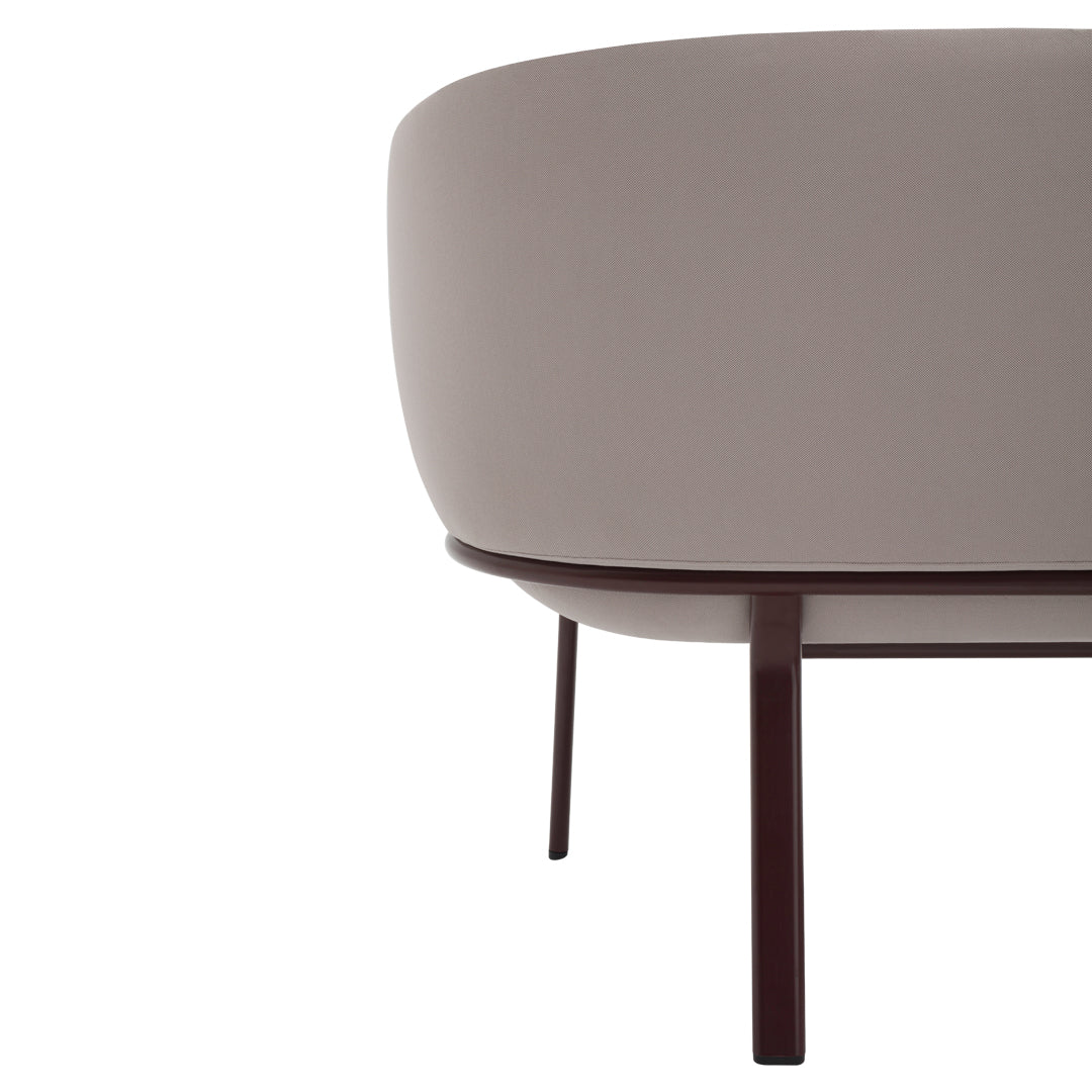 Soft beige curved sofa with a smooth finish and dark wooden legs, showcasing a minimalist modern design.