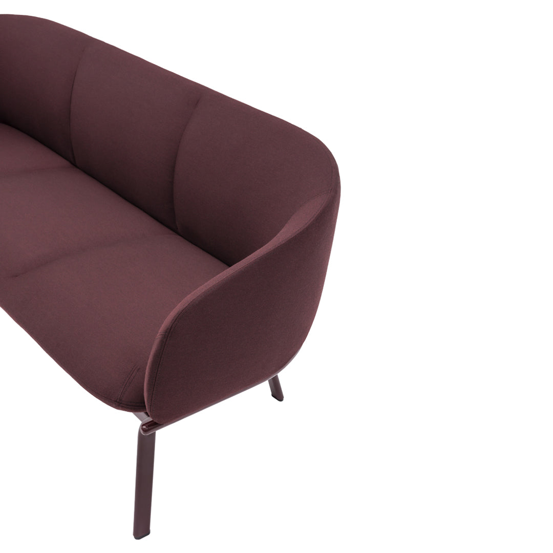 Burgundy fabric sofa with smooth, modern lines and minimalistic design; perfect for contemporary spaces.