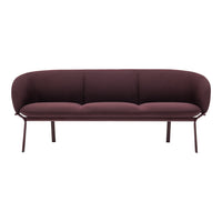 Burgundy curved sofa with smooth fabric upholstery and sleek metal legs, perfect for modern living spaces.