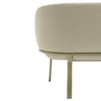 Soft beige upholstery with a textured finish, paired with sleek green metal legs for a modern touch.