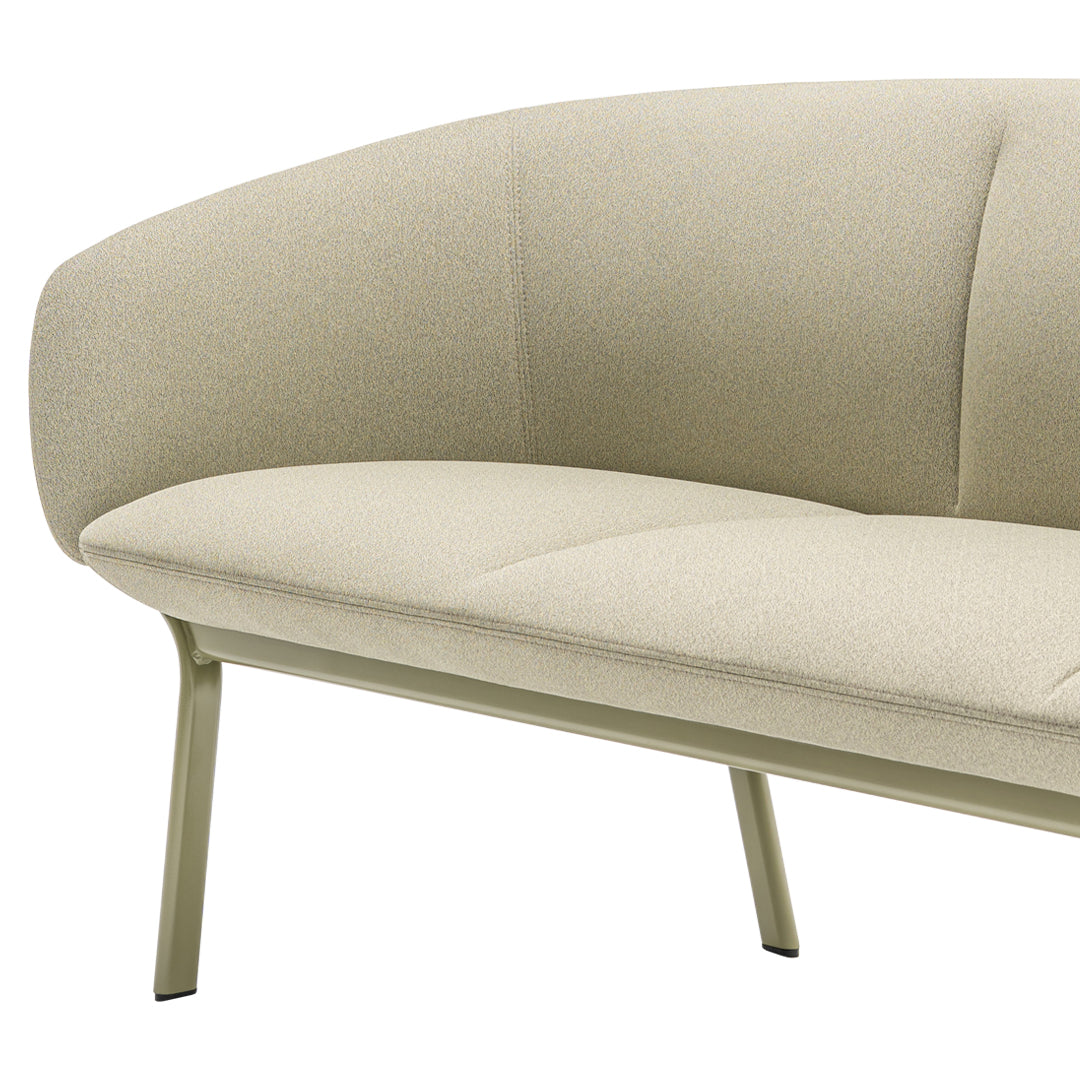 Light beige curved sofa with a smooth fabric texture and minimalist metal legs. Modern and stylish for any decor.