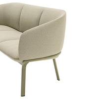 Soft beige upholstered sofa with subtle texture and green metal legs, perfect for modern living spaces.