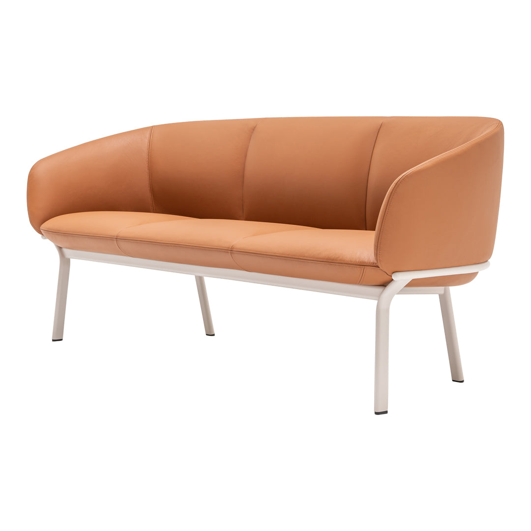 "Soft orange leather sofa with sleek white legs, featuring a minimalist design and smooth, curved lines."