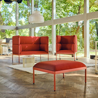 "Modern red upholstered chairs with sleek metal frames, featuring a minimalist design in a bright, airy setting."