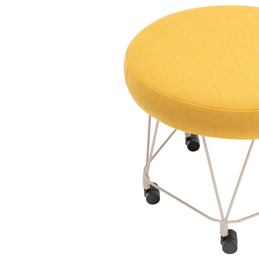 Yellow round ottoman on wheels with a textured fabric and white metal base. Perfect for modern interiors.