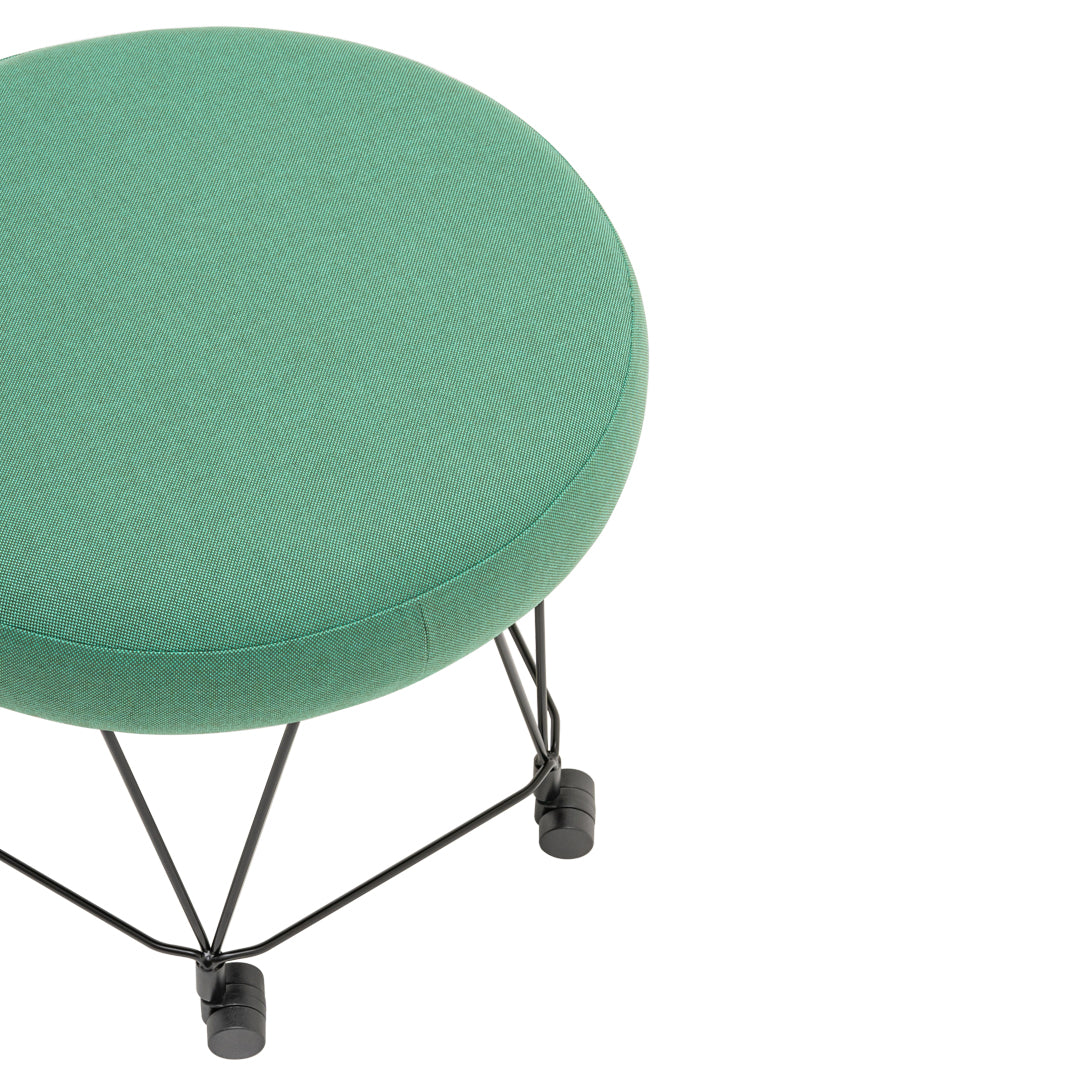 Round green upholstered stool with a smooth texture and black wire base. Perfect for modern decor.
