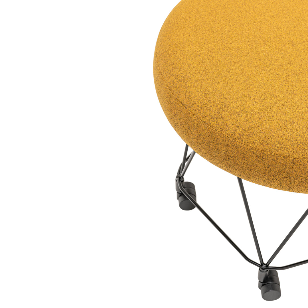 Round mustard yellow ottoman with a textured fabric and black wire base. Perfect for modern home decor.