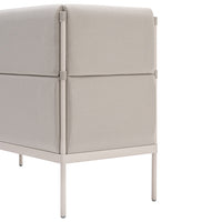 Beige fabric storage ottoman with a smooth texture and minimalist design, featuring sleek light-colored metal legs.