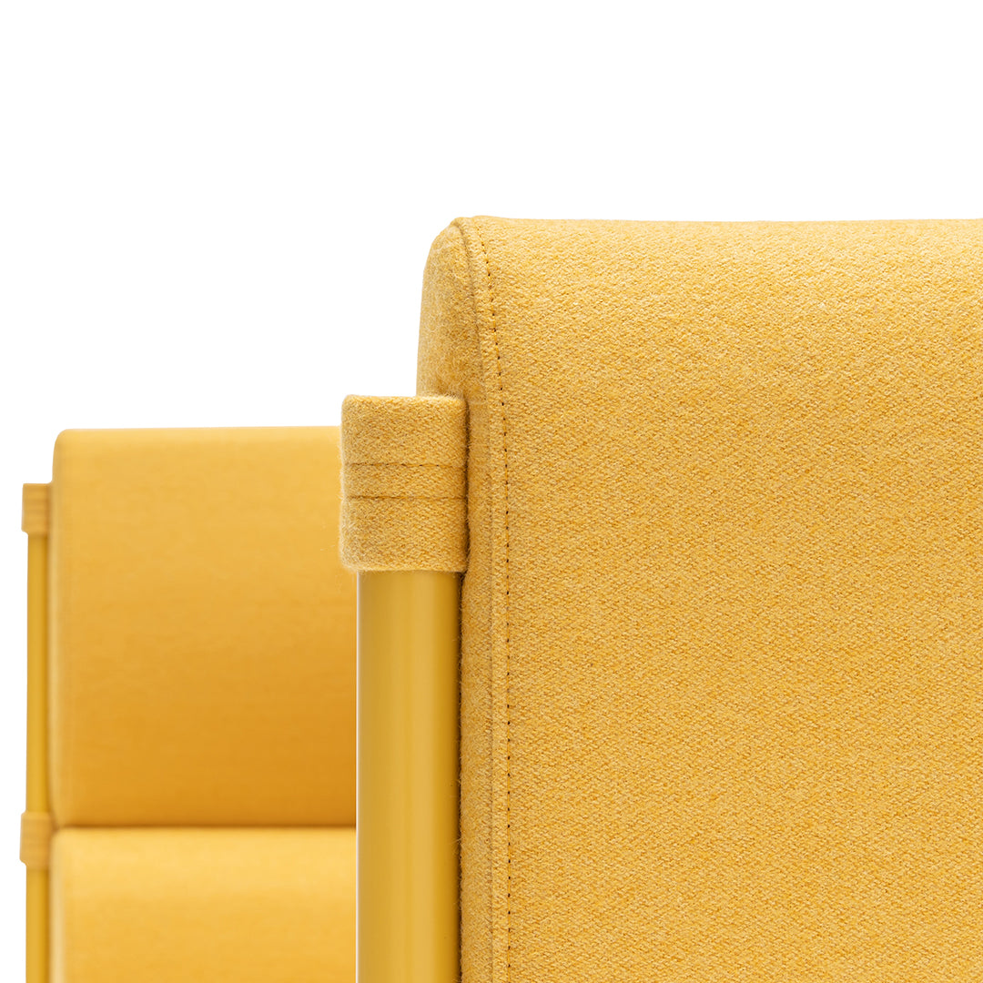 Vibrant yellow upholstered chair with a smooth texture and clean lines, perfect for modern decor.