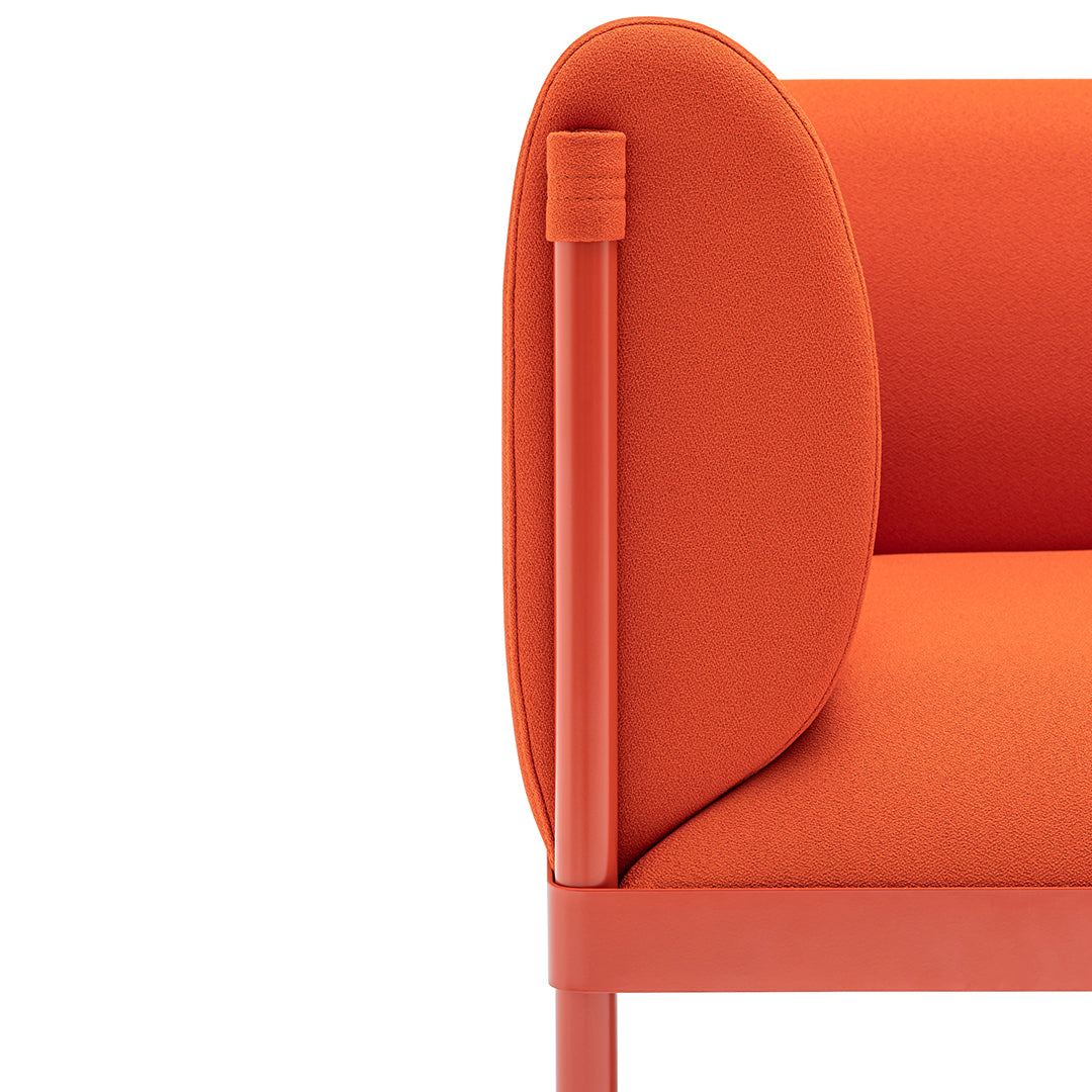 Vibrant orange couch with smooth, rounded edges and a sleek, modern design. Perfect for contemporary living spaces.