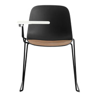 Black chair with a wooden seat and white armrest, featuring a sleek, minimalist design. Perfect for modern decor.