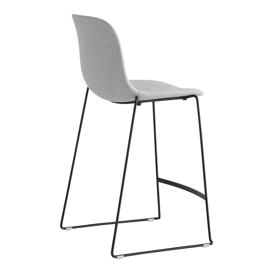 Gray upholstered bar stool with a minimalist design and sleek black metal legs. Perfect for modern interiors.
