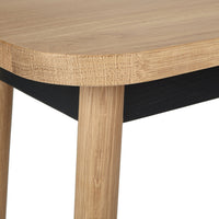Wooden table with a natural bamboo finish and contrasting black base, featuring smooth rounded edges.