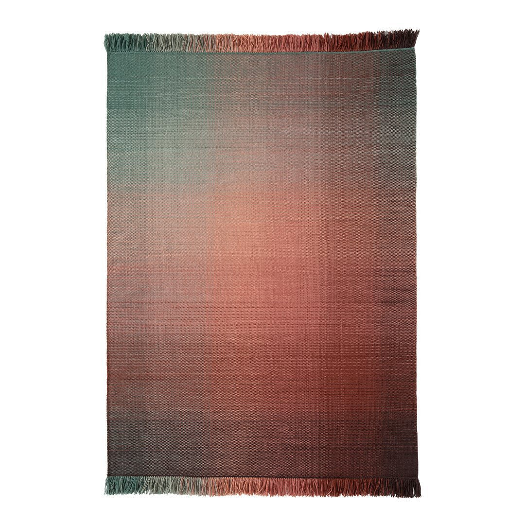 Gradient rug featuring a blend of teal, coral, and soft neutrals with fringe edges for a modern touch.
