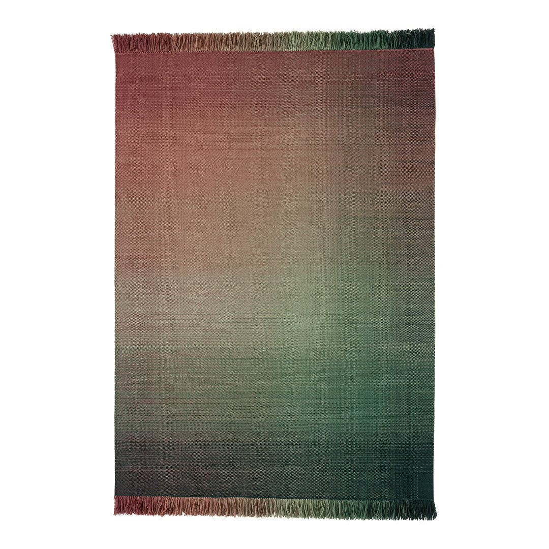 Gradient woven rug featuring rich burgundy, green, and subtle earth tones with fringed edges. Perfect for cozy decor.