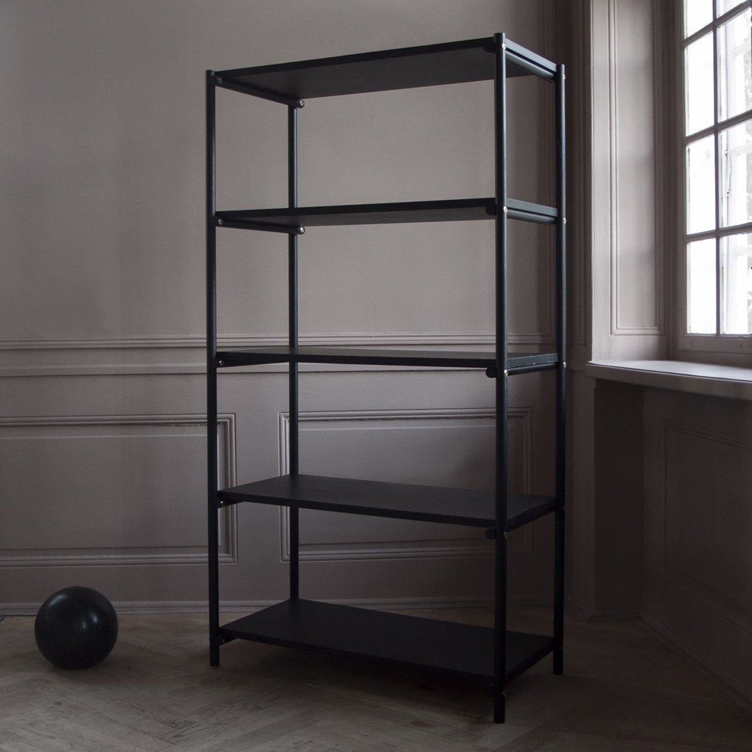 Four-shelf black metal storage unit against a light gray wall, featuring a minimalist design with clean lines.