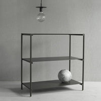 Sleek black metal shelving unit with two shelves, minimalist design against a soft gray background.