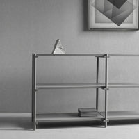 Modern gray shelving unit with clean lines and a minimalist design, featuring a smooth finish and geometric patterns.