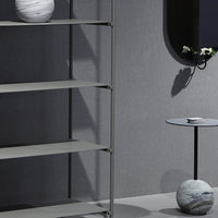 Modern gray shelving unit with sleek metal accents and subtle stoneware decor, showcasing minimalist design.