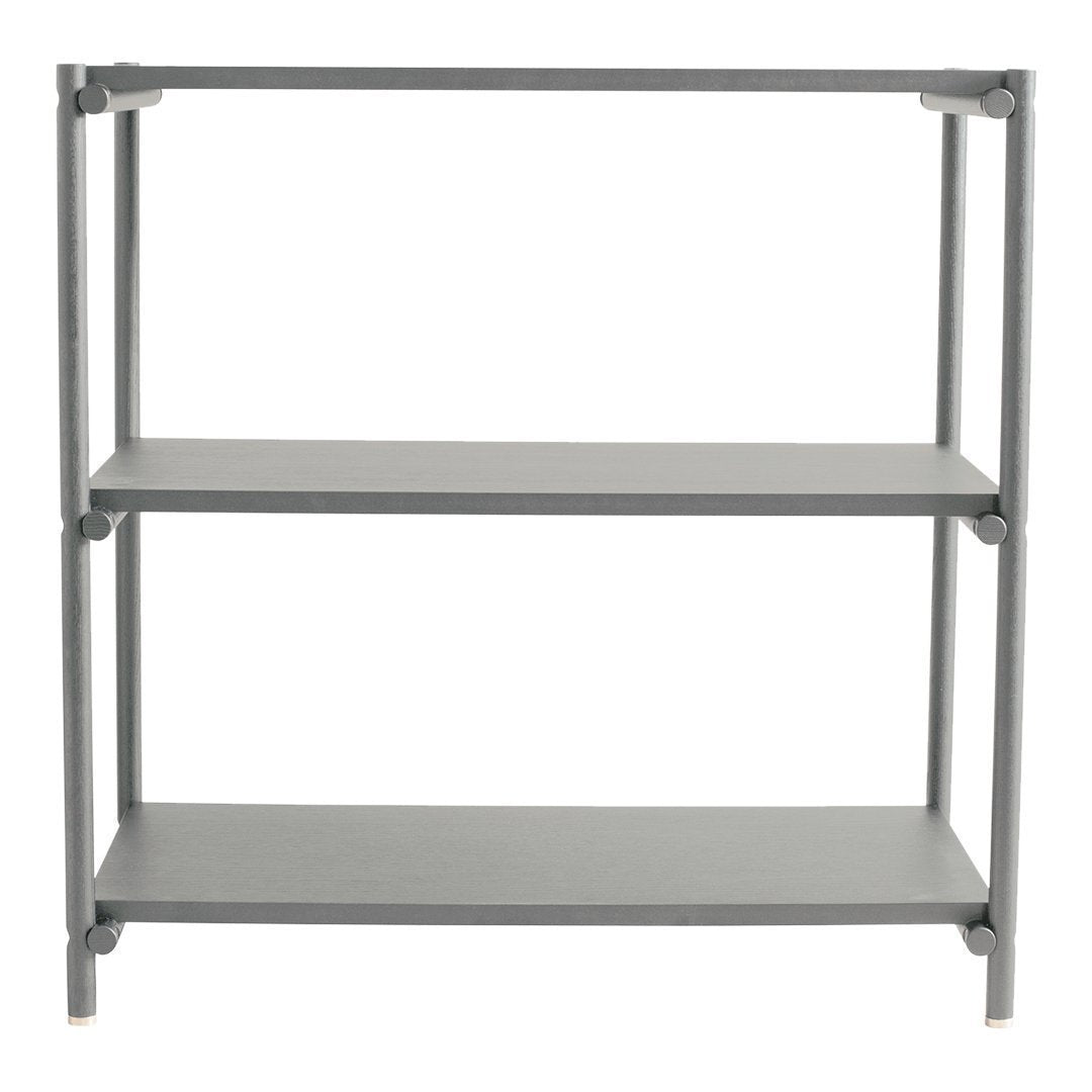 Gray metal shelving unit with a minimalistic design, featuring three open shelves and sleek, clean lines.