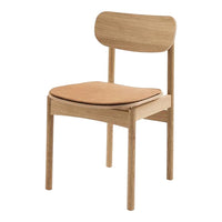 Natural wood chair with a light oak finish and a tan leather seat, featuring a simple, modern design.