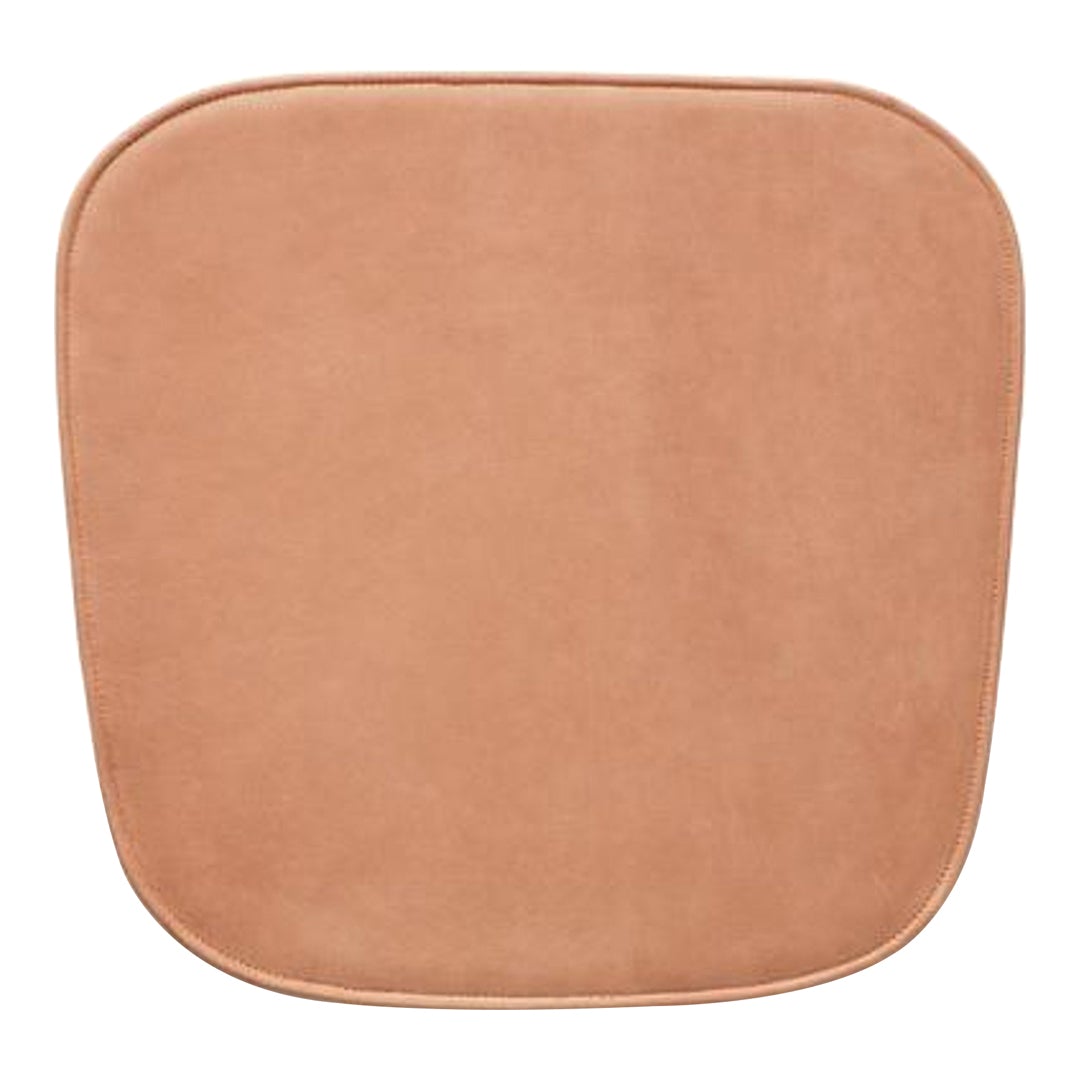 Soft, smooth, square cushion in warm tan with rounded edges, perfect for any modern decor.