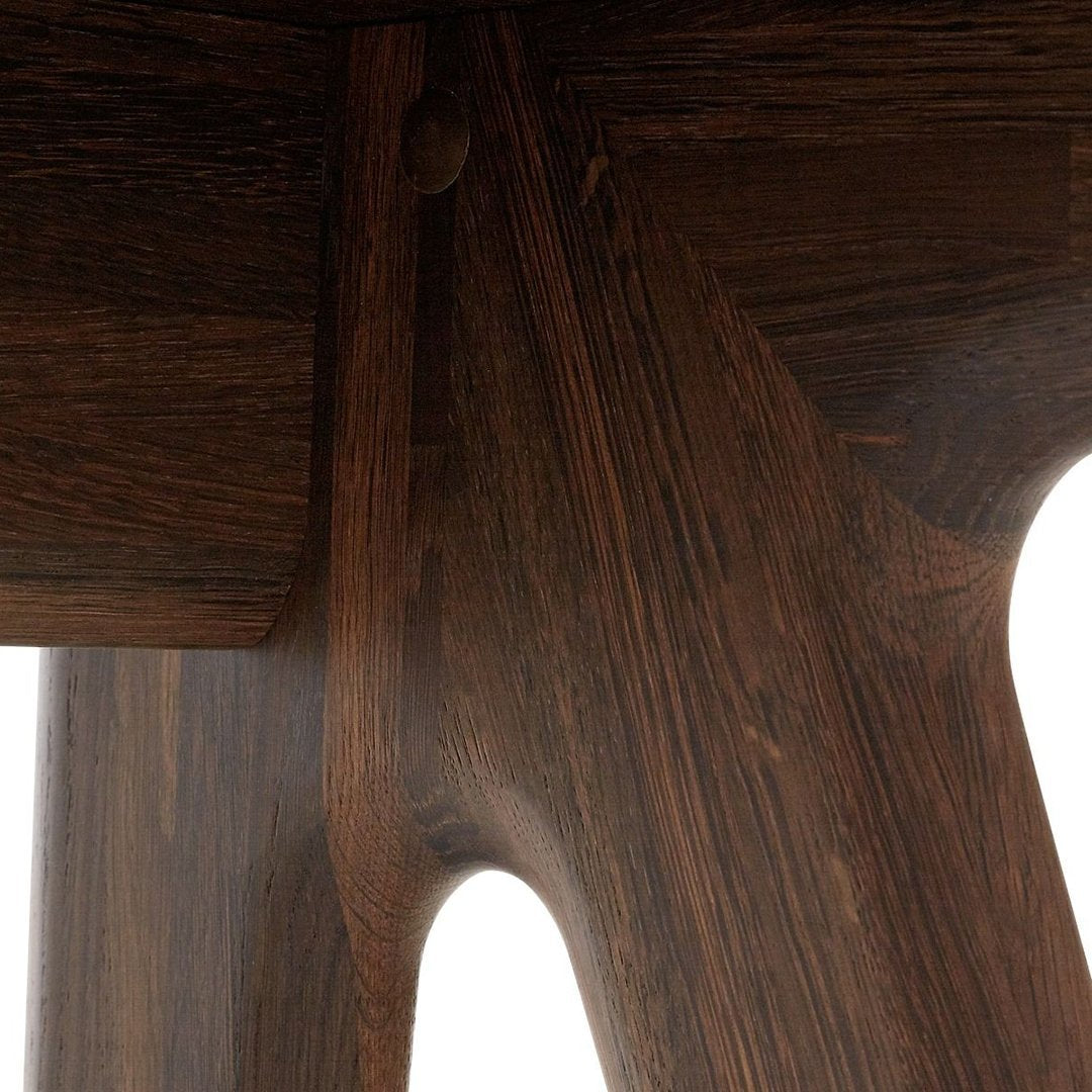 Close-up of dark brown wood with a smooth, natural grain pattern, showcasing elegant craftsmanship and rich texture.
