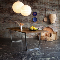 Wooden table with a rustic finish, surrounded by earthy tones and warm, round paper lanterns.