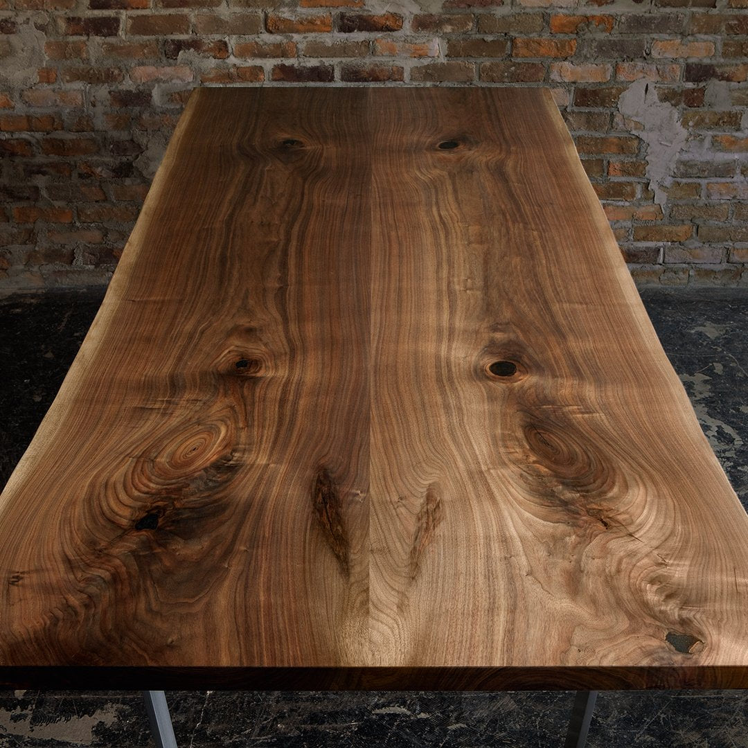 Natural walnut wood table with rich brown hues and distinctive grain patterns, perfect for rustic decor.