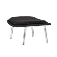Black cushioned ottoman with a sleek silver metal frame, featuring smooth curves and minimalist design.