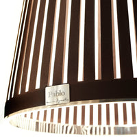 Brown striped lampshade with alternating white stripes and a silver logo detail. Elegant and modern design.
