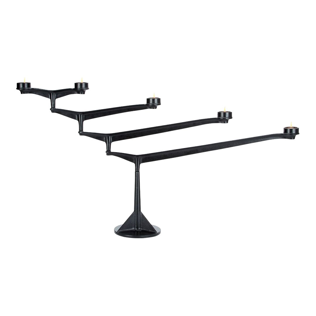 Black candle holder with sleek, modern design featuring four arms and a stylish base. Perfect for contemporary decor.