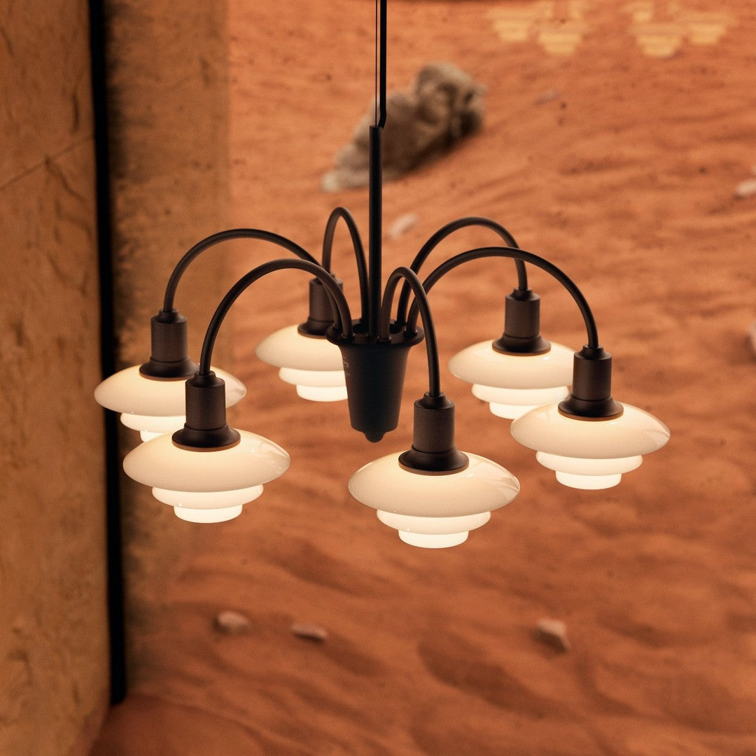 Seven-light chandelier with a matte black finish and cream glass shades, featuring a sleek, modern design.