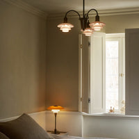 "Elegant beige walls with soft pink glass lampshades and warm yellow lamp glow, creating a cozy ambiance."