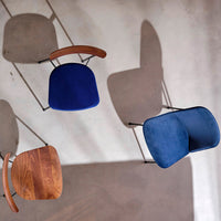 "Stylish chairs in deep blue and brown tones, featuring sleek velvet upholstery and modern geometric shapes."
