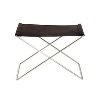 Brown leather seat with a smooth texture on a sleek silver metal frame, featuring a minimalist X-shaped design.