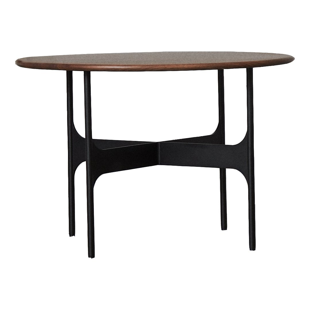 Mid-century modern round table with a rich walnut top and sleek black metal legs, featuring a minimalist design.